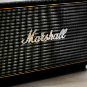 A simple image of a Marshall amp head. The main focus on this photo is the Marshall logo in the center.