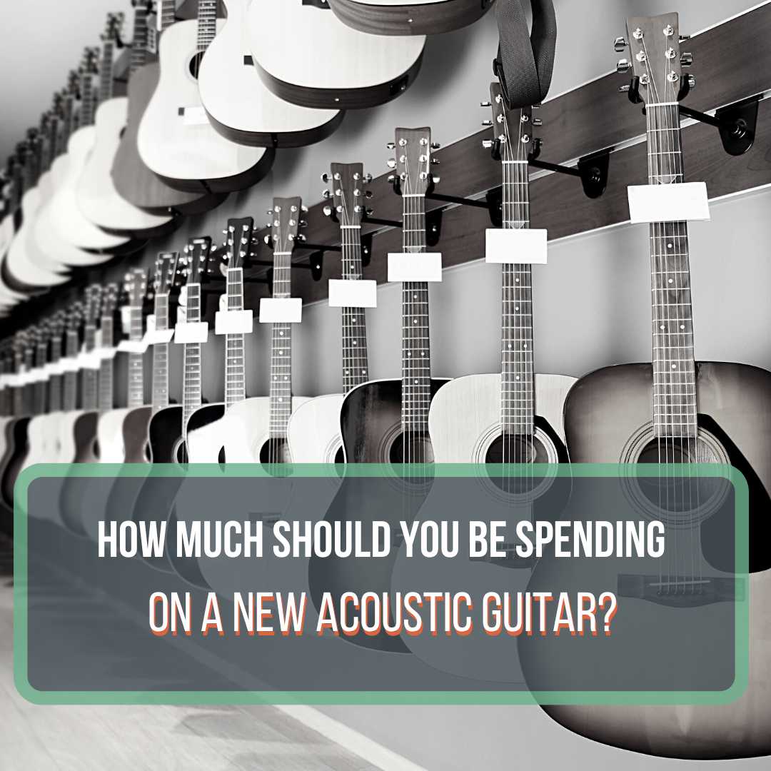 This is a black and white picture of multiple acoustic guitars hanging on a wall at a guitar shop. This is a featured image for the blog post "How much does an acoustic guitar cost?"