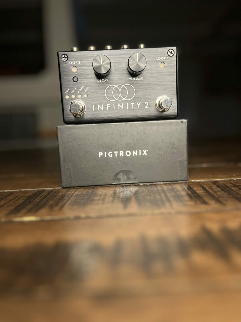 A close up picture of the Pigtronix Infinity 2 and Packaging. This picture helps you see the controls that are on the pedal.