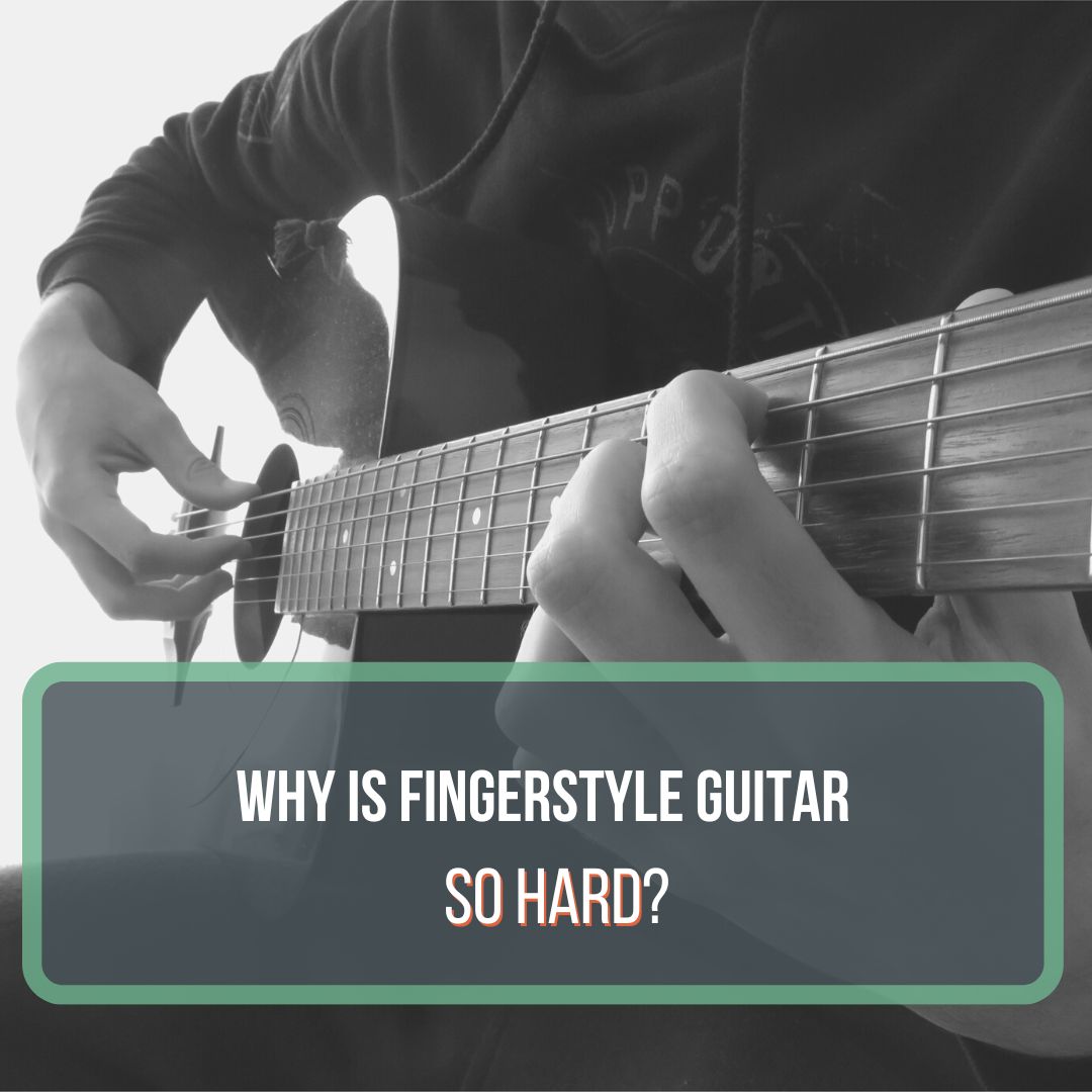 This is a featured image for the blog post "Why is fingerstyle guitar so hard?" This picture is black and white and shows a male player strumming an acoustic guitar with his fingers.